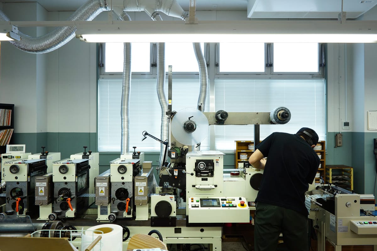 Worker operating a printing machine